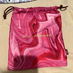 A cute “self love is the best love” pink jaw string mini bag for accessories